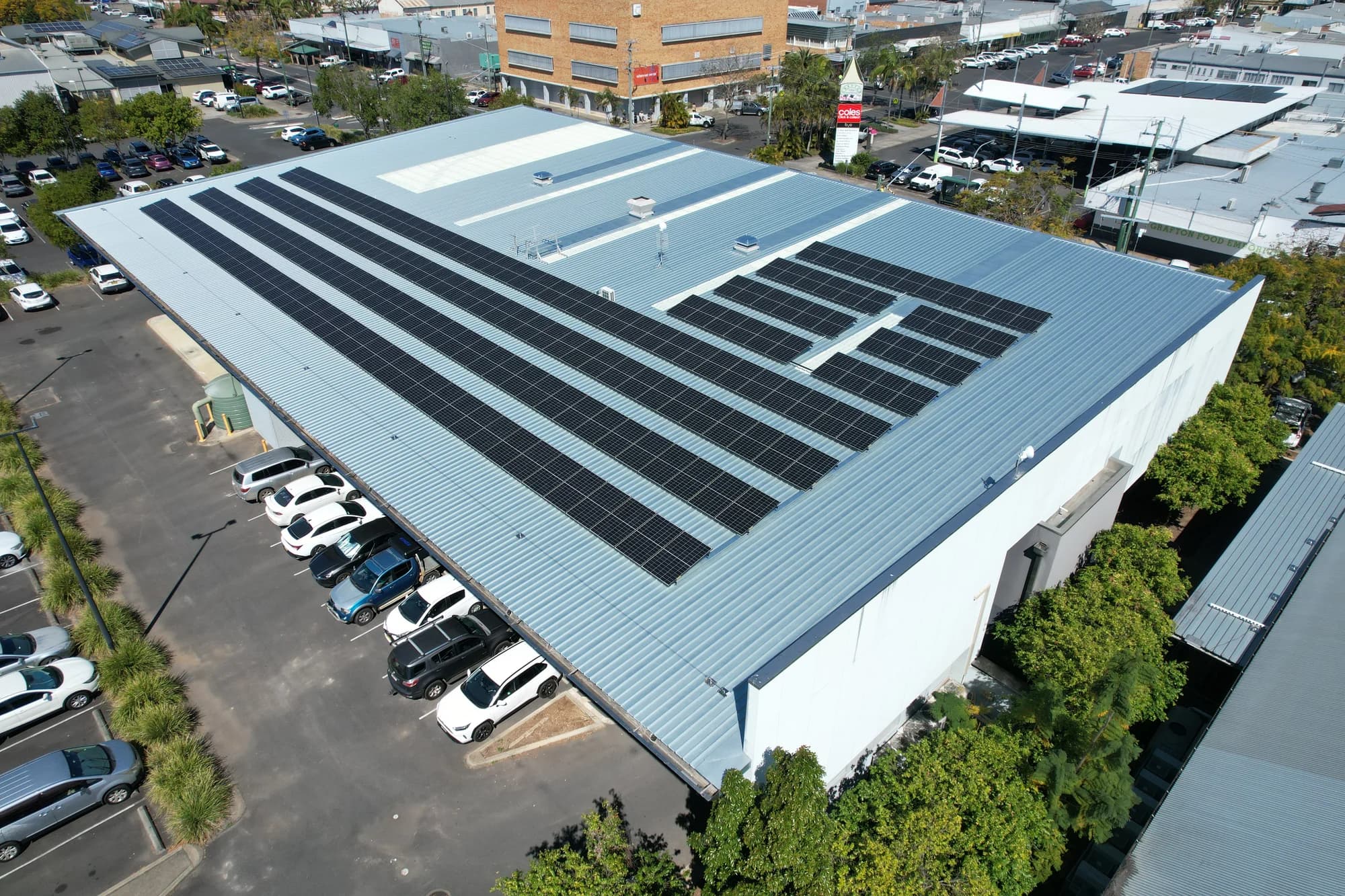 Closer drone view of six rows of tilted panels across the Grafton Library roof